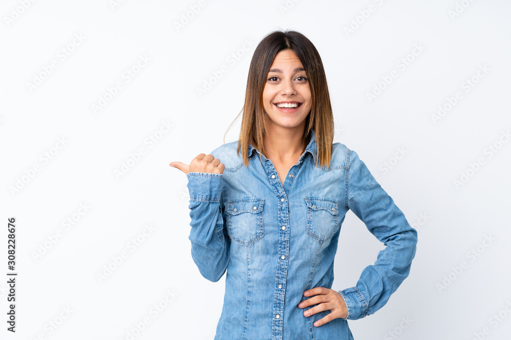 Young woman over isolated white background pointing to the side to present a product Young woman over isolated white background pointing to the side to present a product