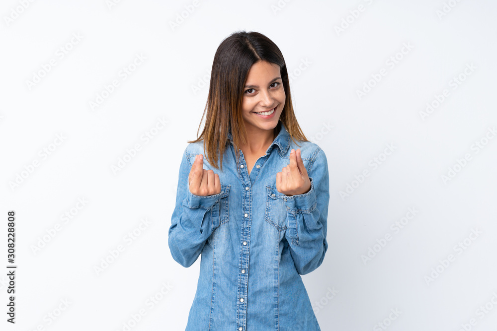 Young woman over isolated white background making money gesture Young woman over isolated white background making money gesture