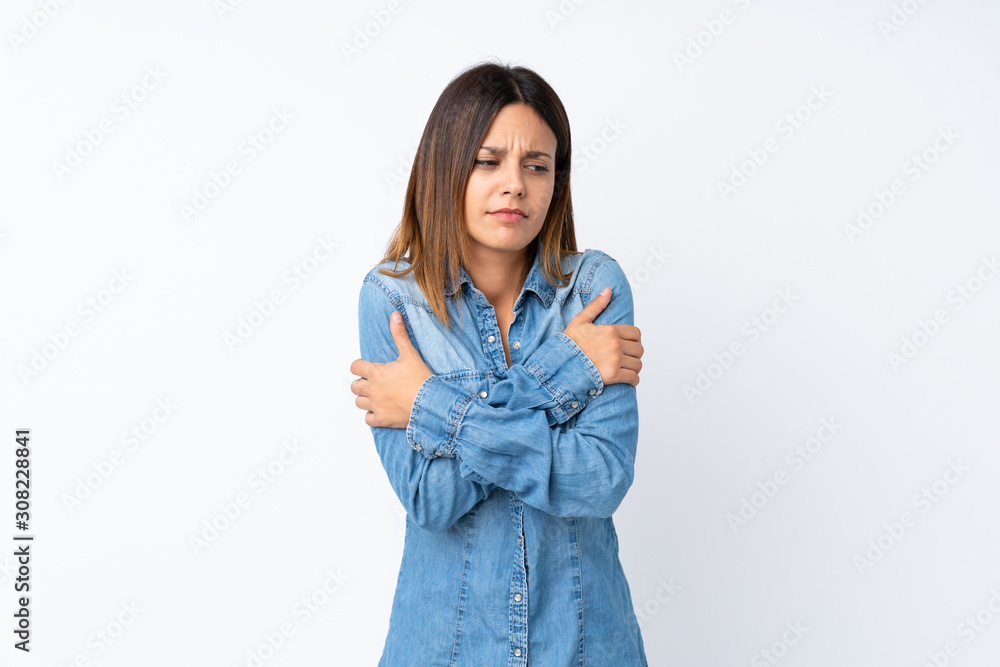 Young woman over isolated white background freezing Young woman over isolated white background freezing