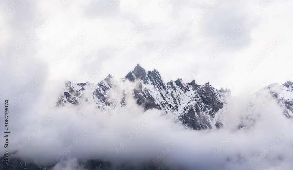 Panoramic snow mountain with white cloudy sky