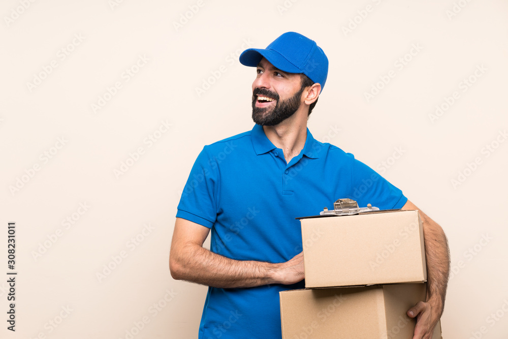Delivery man with beard over isolated background happy and smiling Delivery man with beard over isolated background happy and smiling