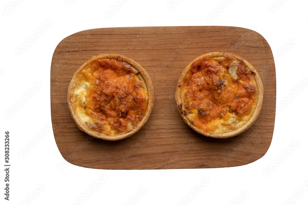 Two small homemade quiches on a board Two small homemade quiches on a board