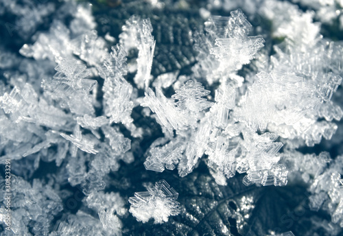 winter background with snowflakes crystals patterns and snow on frozen grass