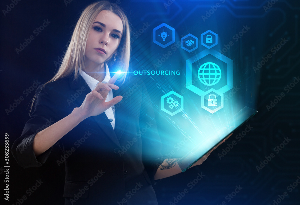 Business, Technology, Internet and network concept. Young businessman working on a virtual screen of the future and sees the inscription: Outsourcing Business, Technology, Internet and network concept. Young businessman working on a virtual screen of the future and sees the inscription: Outsourcing