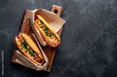 Photography french hot dogs from the store  packaged in paper, baked with cheese and mustard