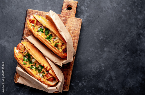 Sticker french hot dogs from the store  packaged in paper, baked with cheese and mustard