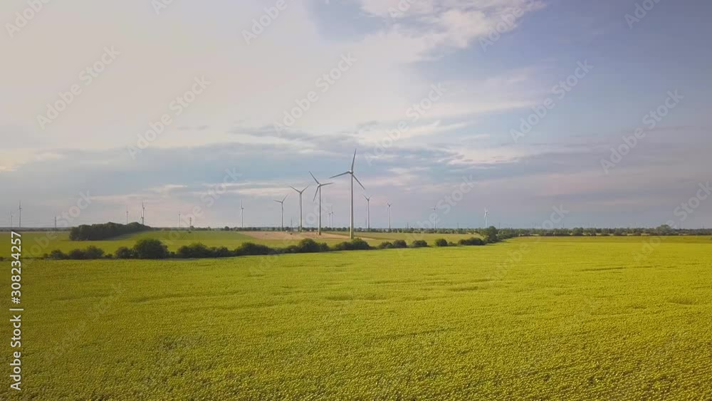 Aerial view of wind turbine generators in field producing clean ecological electricity. Aerial view of wind turbine generators in field producing clean ecological electricity.