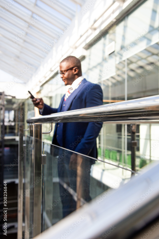 Portrait of a businessman in suit are standing on the background of glass offices. Portrait of a businessman in suit are standing on the background of glass offices.