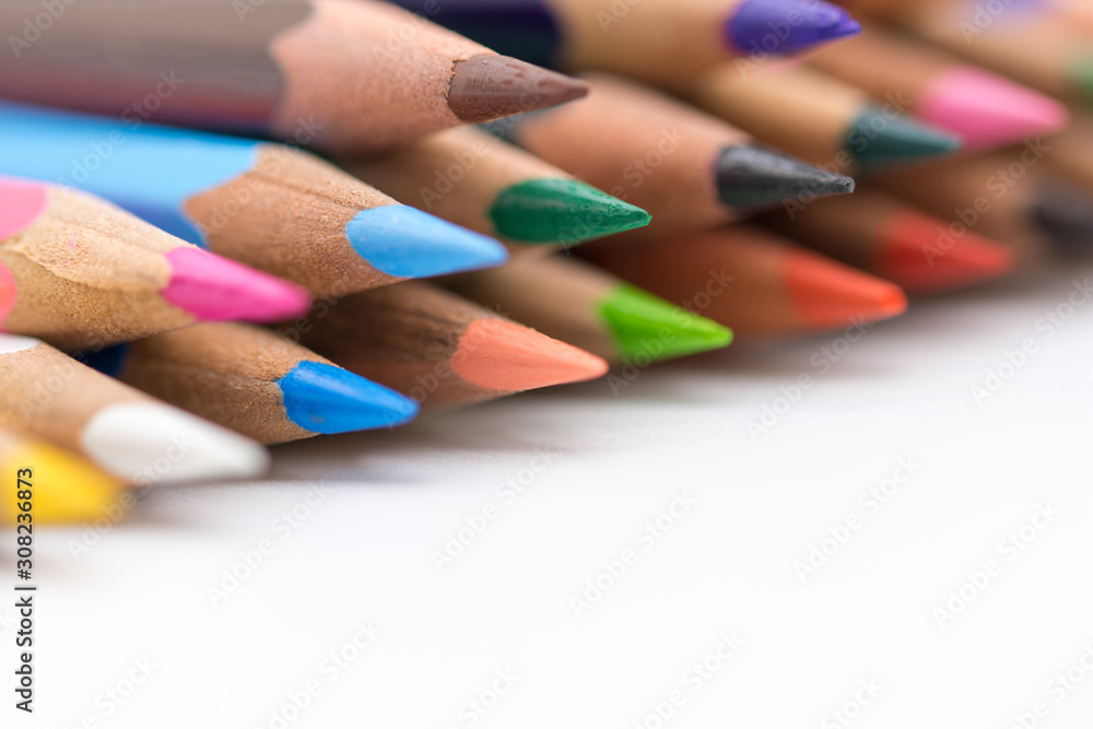 close up colored crayons stacked on whive background concept photo close up colored crayons stacked on whive background concept photo
