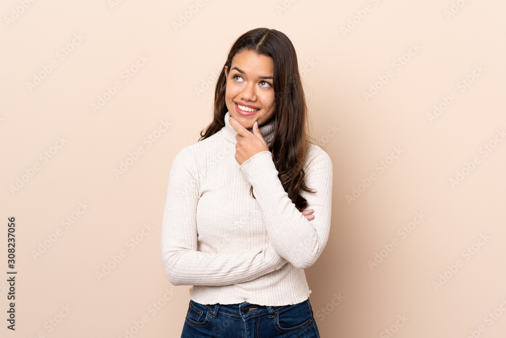 Young Colombian girl over isolated background looking to the side Young Colombian girl over isolated background looking to the side