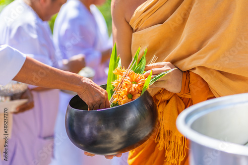 The monks of the Buddhist Sangha(give alms to a Buddhist monk), which came out of the Buddhist offerings in the morning. In order to demonstrate faith faithfully perform the duties recently.