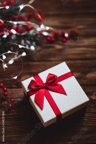 Christmas presents with red ribbon on dark wooden background in vintage style