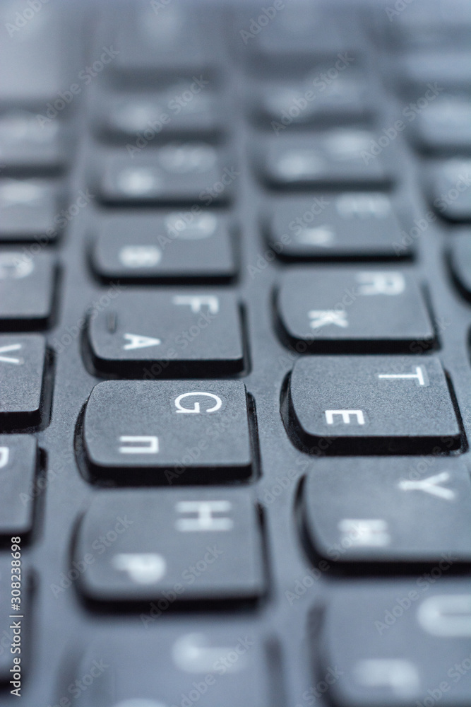 Closeup black keyboard with Ukrainian and English alphabet layout. Closeup black keyboard with Ukrainian and English alphabet layout.