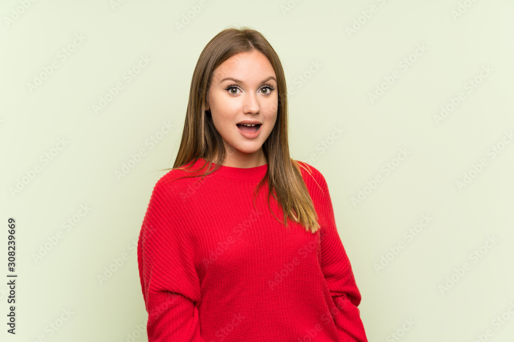 Teenager girl over isolated green background with surprise facial expression Teenager girl over isolated green background with surprise facial expression