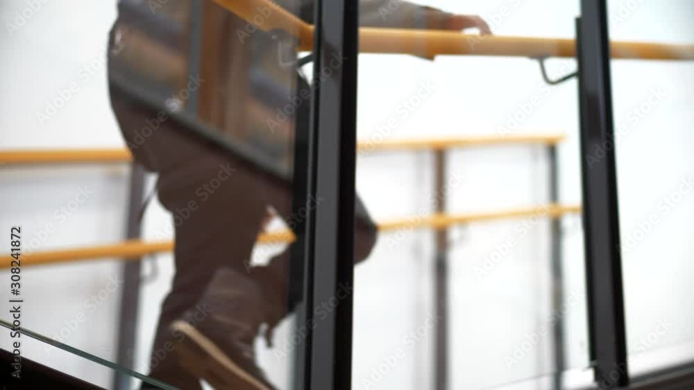 Elementary boy walking up stairs at school, Low shot Elementary boy walking up stairs at school, Low shot