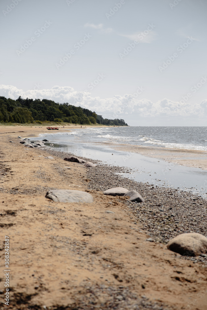 Fototapeta premium Moody foggy landscape at a Baltic Sea gulf in Jurmala Latvia beach - Boat in the background