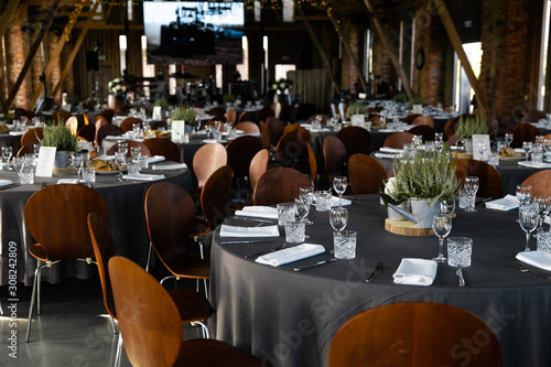 Food served on round table in a white hall during a Birthday corporate party in Eastern European Baltic Riga Latvia - Wooden ambar hall in countryside style - Canape, snacks and light drinks