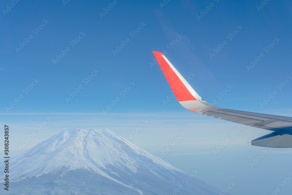 A plane passing through the view of Lake Kawaguchiko in Japan A plane passing through the view of Lake Kawaguchiko in Japan
