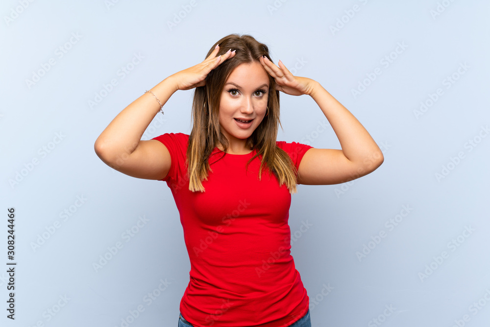 Teenager girl over isolated blue background with surprise facial expression Teenager girl over isolated blue background with surprise facial expression