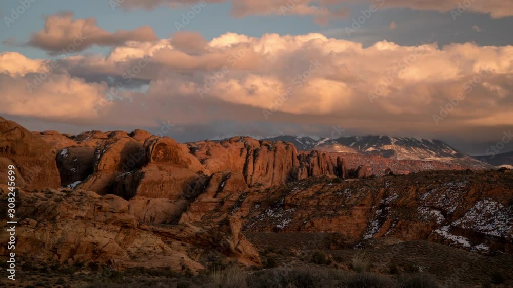 Timelapse of colorful sunset over desert rocky fin layers in Moab looking towards the La Sal Mountains as the clouds change colors. Timelapse of colorful sunset over desert rocky fin layers in Moab looking towards the La Sal Mountains as the clouds change colors.