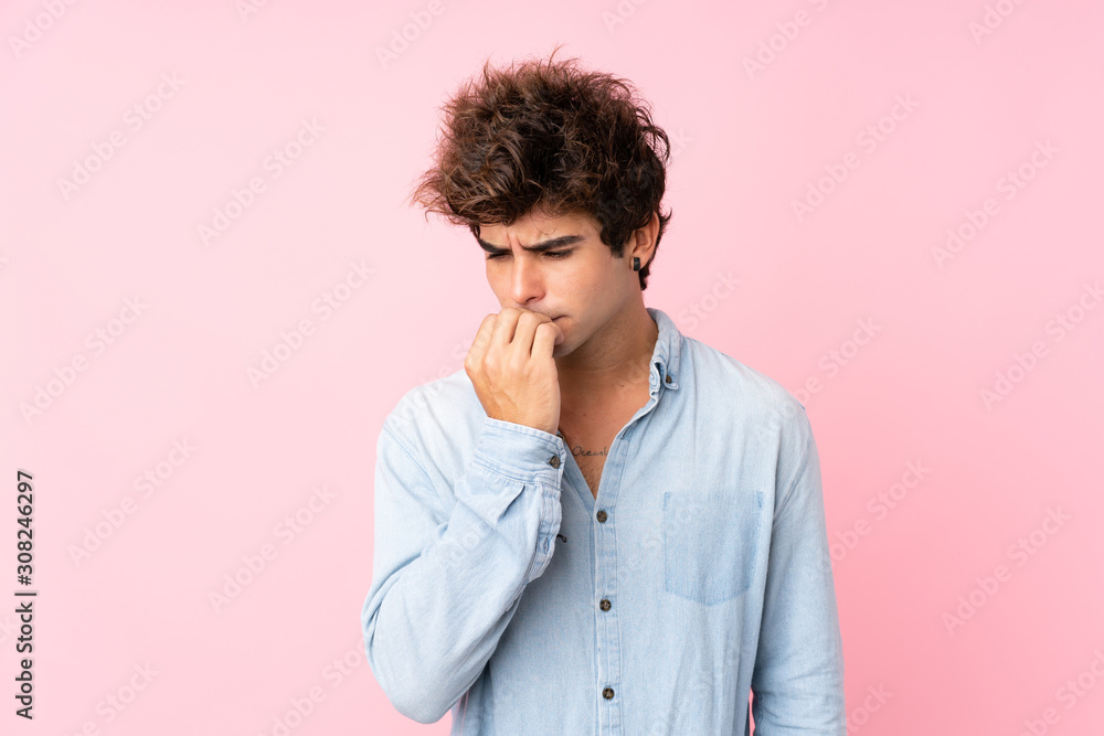 Young caucasian man with jean shirt over isolated pink background having doubts Young caucasian man with jean shirt over isolated pink background having doubts