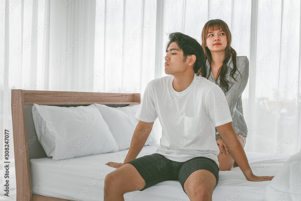 Unhappy couple with problem relationship appear on the bedroom background textures concept. Unhappy couple with problem relationship appear on the bedroom background textures concept.