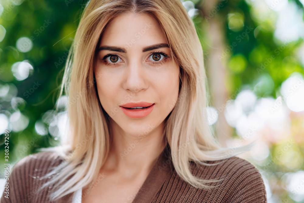 Portrait of a blonde woman looking at the camera closeup Portrait of a blonde woman looking at the camera closeup
