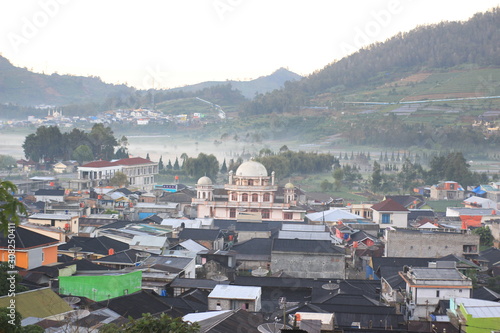 the beauty of the dieng plateau in the morning and the mist enveloping it photo