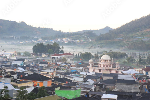 the beauty of the dieng plateau in the morning and the mist enveloping it photo