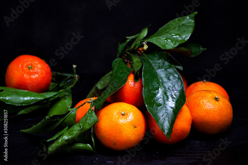 orange tangerines fruits and green leaves