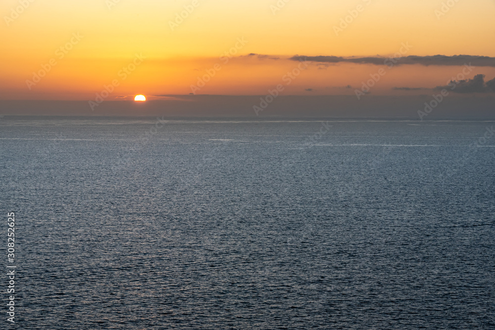 Bright sunset with orange sun above the sea surface. Atlantic ocean. Bright sunset with orange sun above the sea surface. Atlantic ocean.