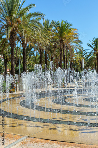 playing fountain in Salou against the background of palm trees on a sunny day. Spain, Costa Dorada