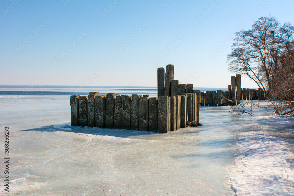 Fototapeta premium old breakwater in the river