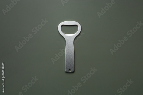 metal bottle opener on dark background photo