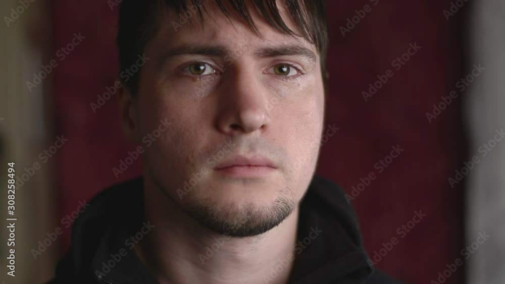 Close up emotional portrait of the young male being angry, frowning and grumpy