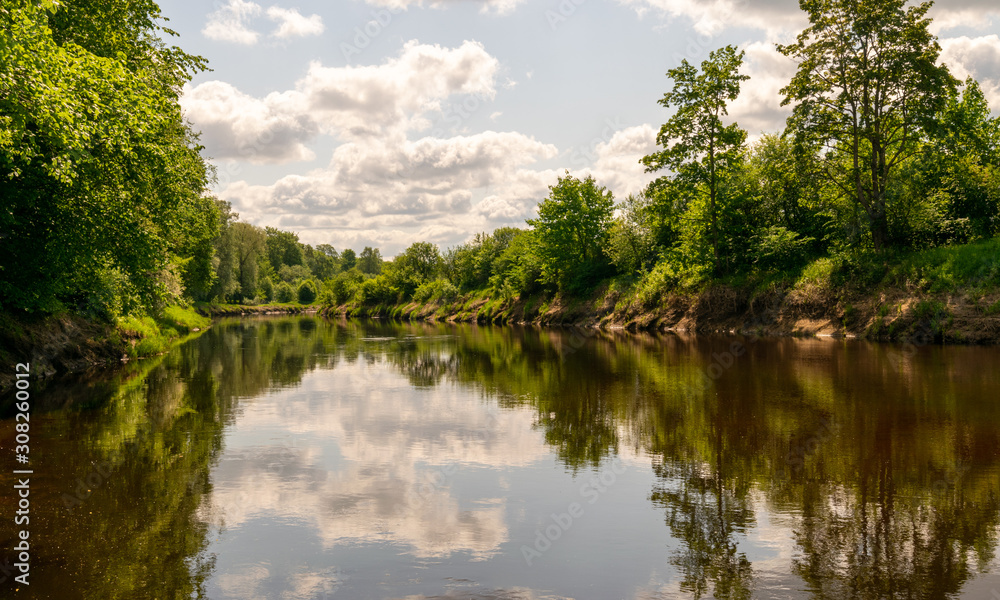 Obraz premium beautiful views of calm water, clouds and tree glare
