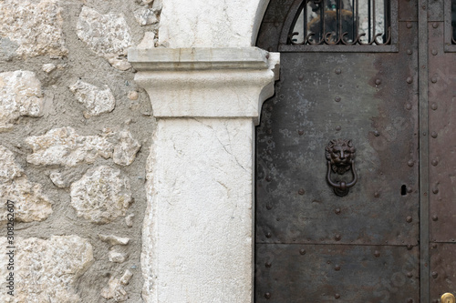 Wallpaper Mural Entrance detail of a medieval palace with a stone wall and a pillar with a Doric capital Torontodigital.ca