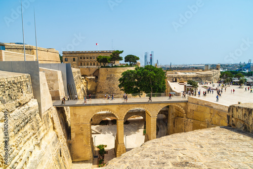 The bridge going over the Ditch to the City Gate of Valletta, Malta. In the background is Saint James Bastion and the Central Bank of Malta.
