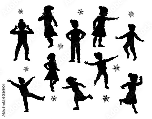A set of children in silhouette playing having fun in Christmas or winter cold weather clothing