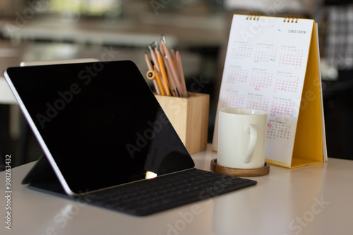 Office Desk workspace top view for present advertising product on tablet screen 
