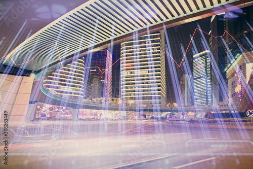 Forex chart on cityscape with tall buildings background multi exposure. Financial research concept.