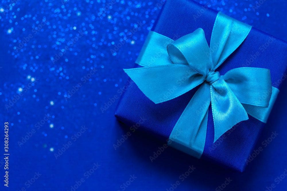 Blue gift box with aque mint bow on trendy blue background. Blue gift box with aque mint bow on trendy blue background.