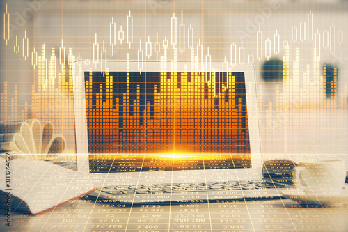 Financial graph colorful drawing and table with computer on background. Multi exposure. Concept of international markets. © peshkova