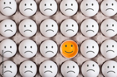 different egg stands out from the crowd and smiling.turn the disadvantage into an advantage