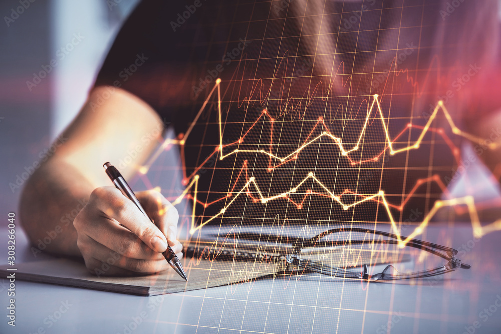 Multi exposure of woman's hands making notes with forex graph hologram. Concept of technical analysis. Multi exposure of woman's hands making notes with forex graph hologram. Concept of technical analysis.