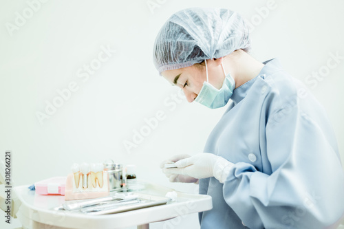 Young woman  dentist is preparing the equipment. Dental materials for preparation Dental treatment for patients.