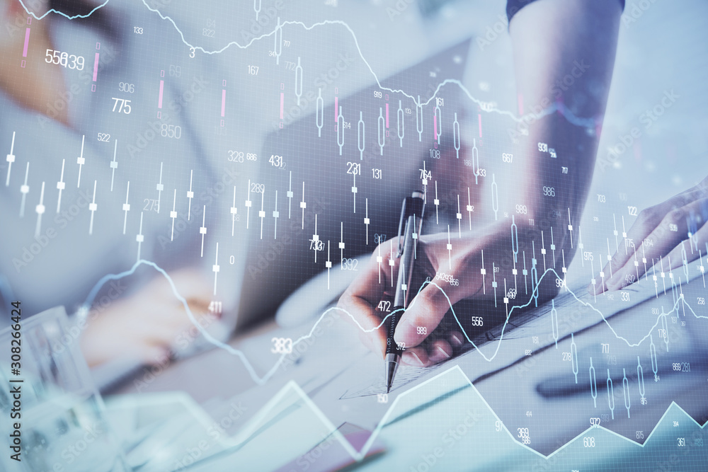 A woman hands writing information about stock market in notepad. Forex chart holograms in front. Concept of research. Double exposure A woman hands writing information about stock market in notepad. Forex chart holograms in front. Concept of research. Double exposure