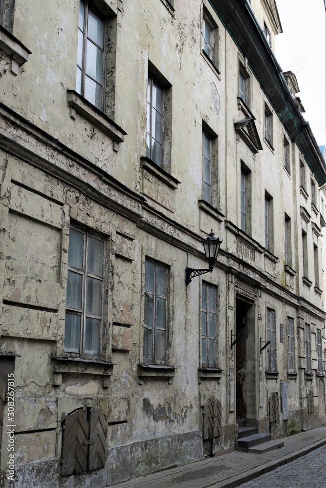 Fototapeta premium Riga, Latvia, November 2019. Facade of an old abandoned house in the historic city center.