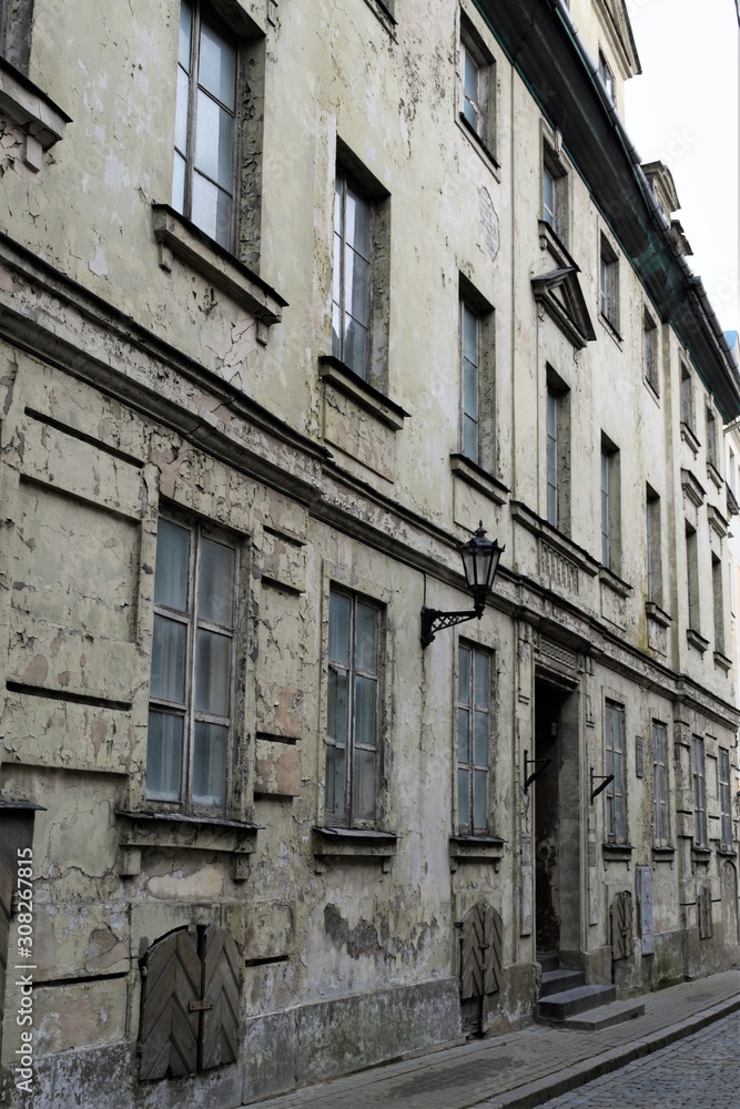 Riga, Latvia, November 2019. Facade of an old abandoned house in the historic city center.
