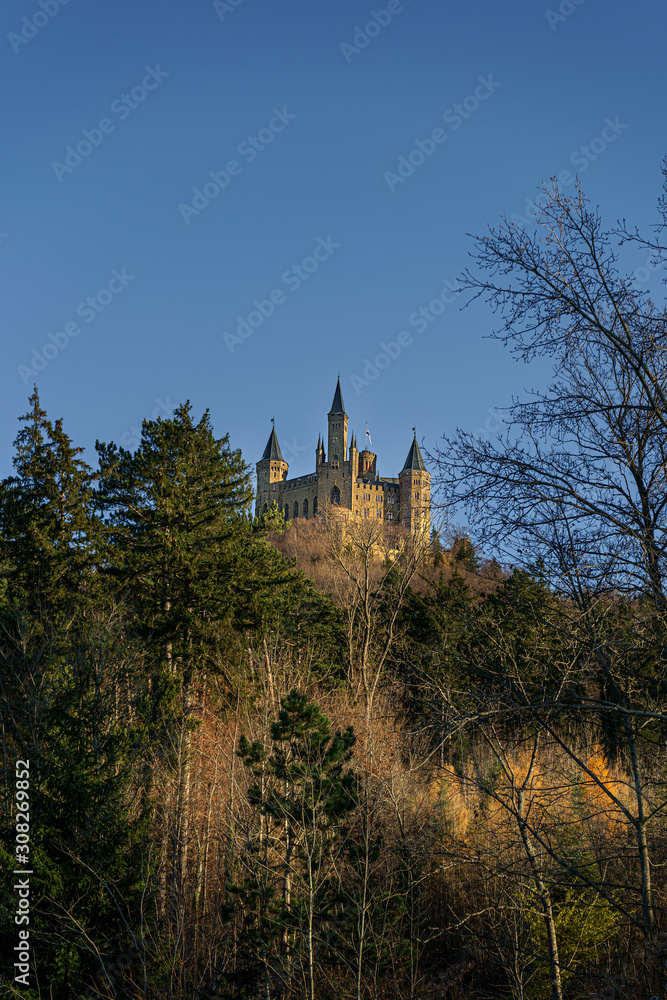 Castle Hohenzollern on a mountain in Germany during sunset at golden hour Castle Hohenzollern on a mountain in Germany during sunset at golden hour
